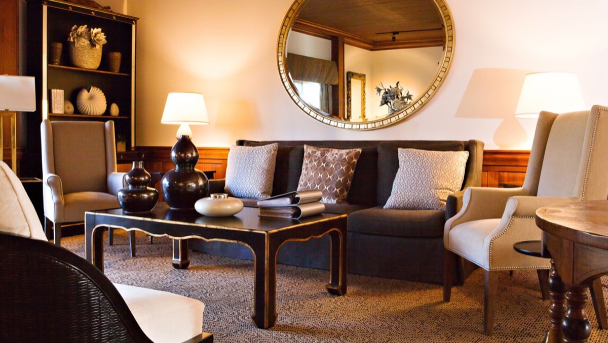 Waiting lounge with armchairs and a round gilded mirror