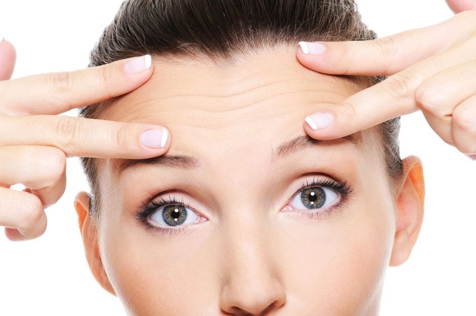Woman simulating a brow lift
