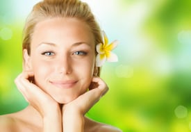 woman holding head with flower in hair