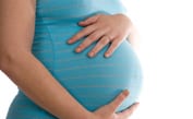 pregnant woman holding stomach