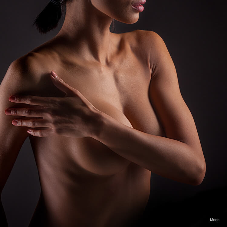 Woman with arms covering her breast