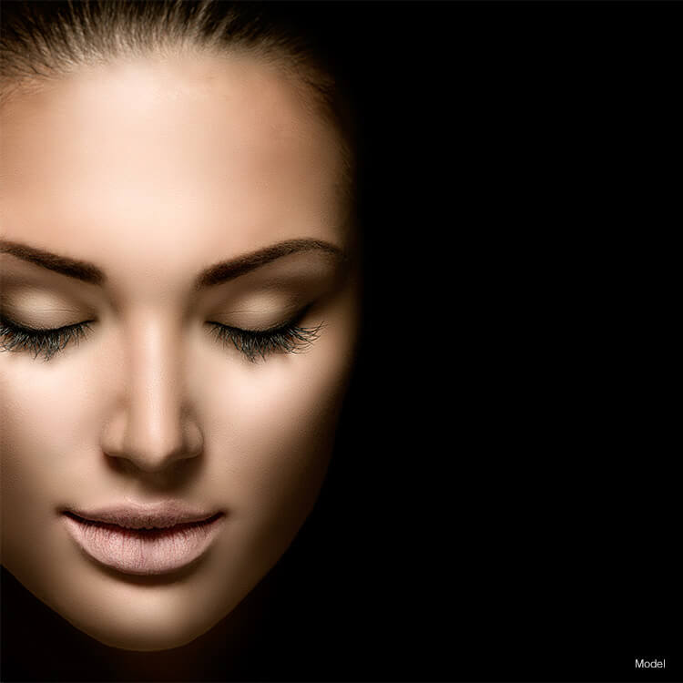 woman smiling with eyes closed