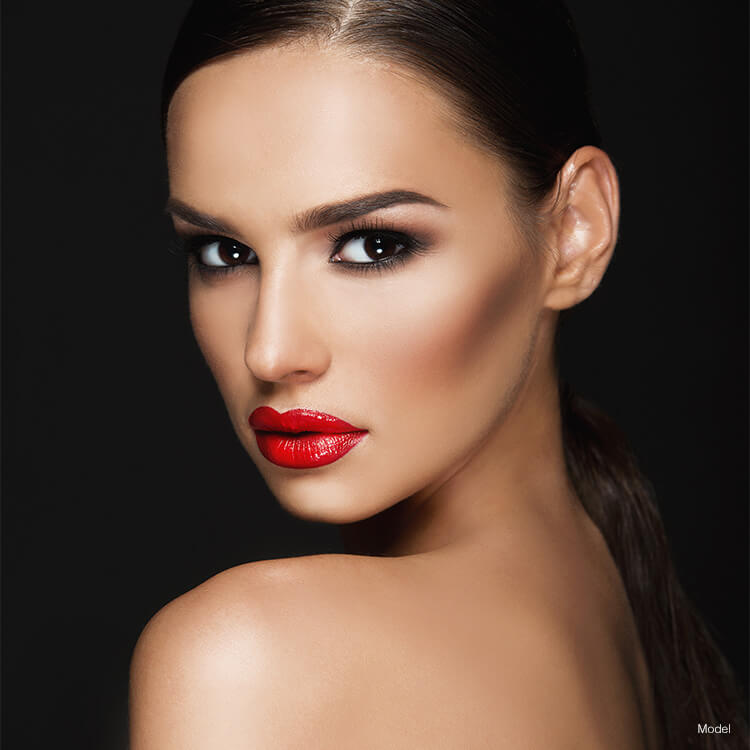 Woman with red lipstick looking over shoulder