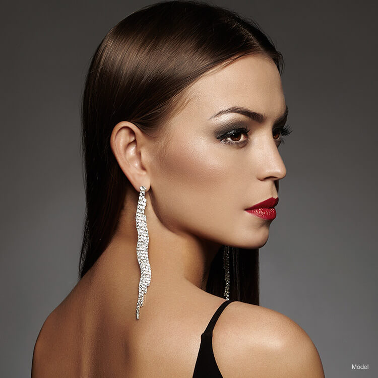 Woman with nice earrings looking over shoulder